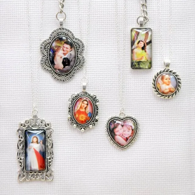 Photo pendants and lockets made at Sun & Sand Studio, each holding a customer's printed photo